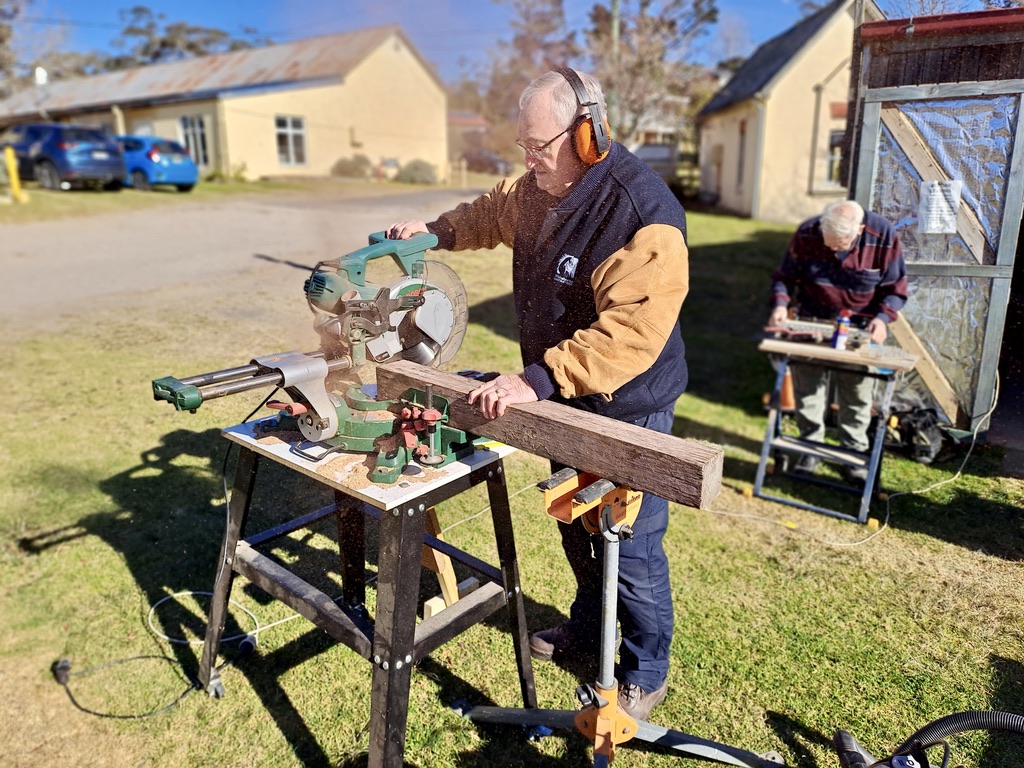 Mens Shed Treasurer Paul Friend squaring up legs for a picnic table.